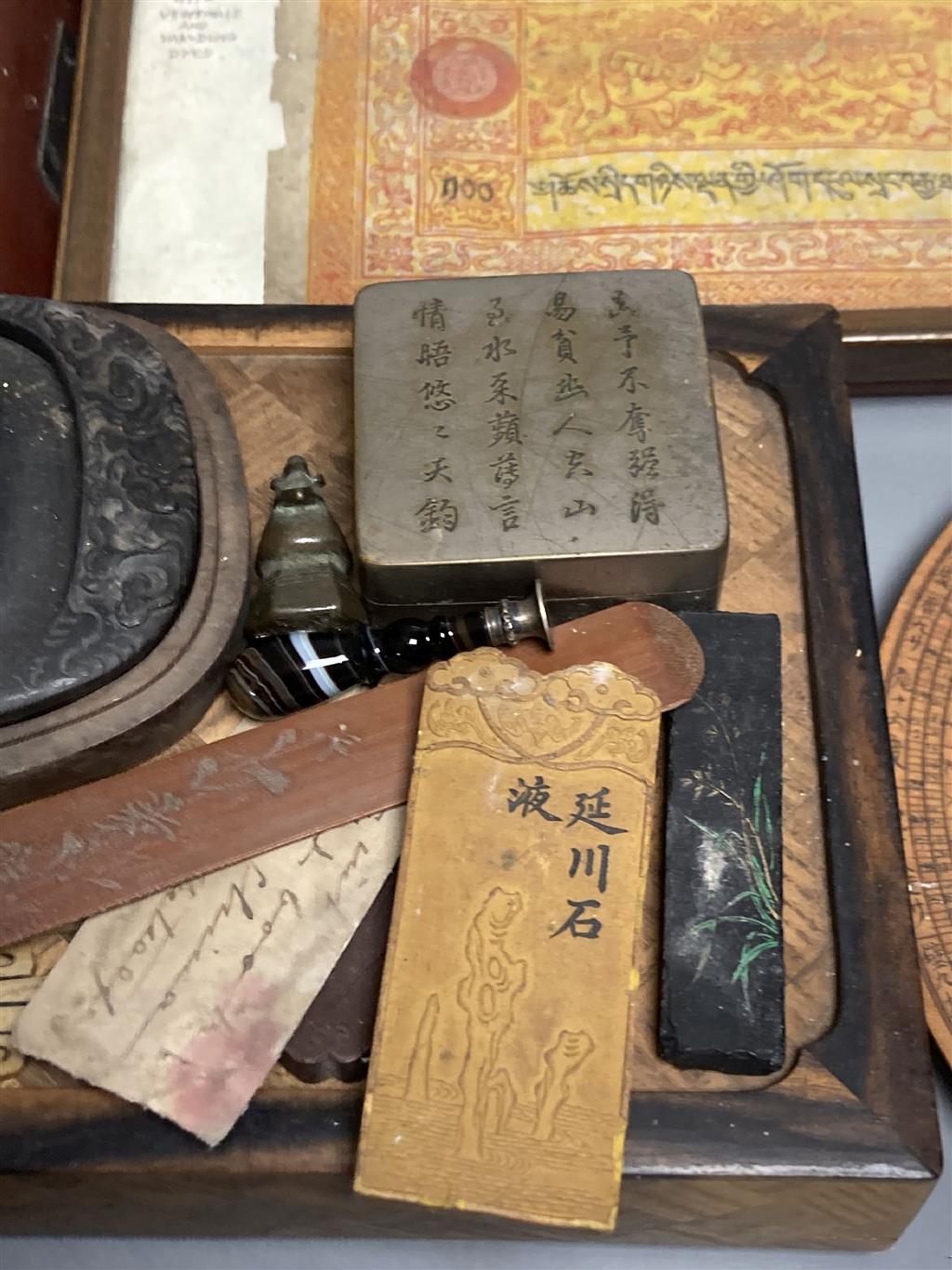 A group of Chinese and Japanese objects, 19th/20th century, including an inscribed ink box an inkstone, a lacquer bookslide, two Tibeta